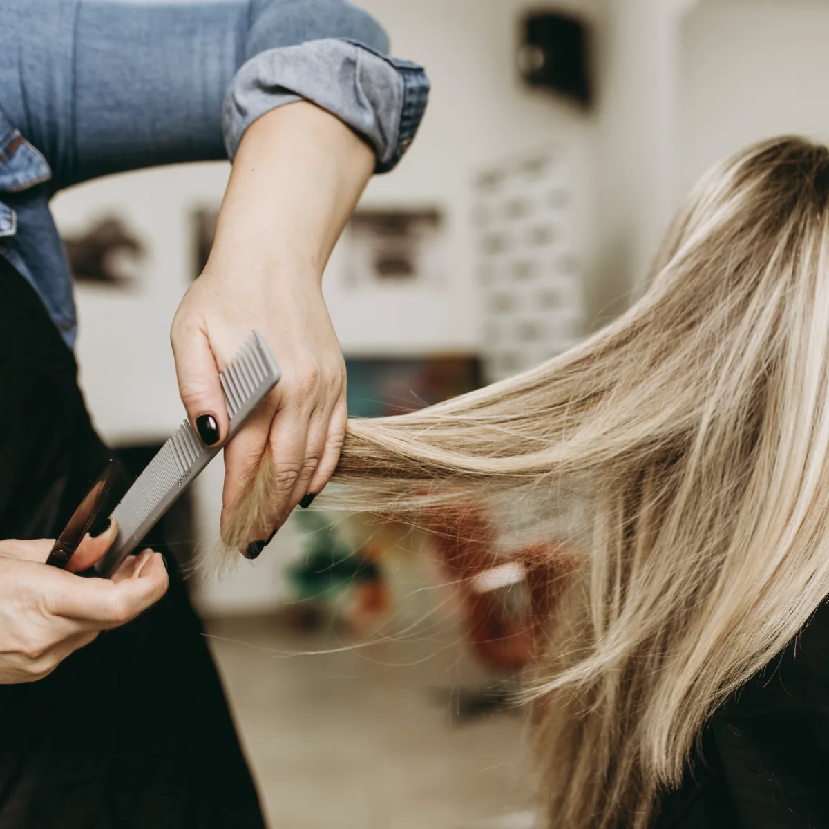 Hands combing through long blonde hair mid-service