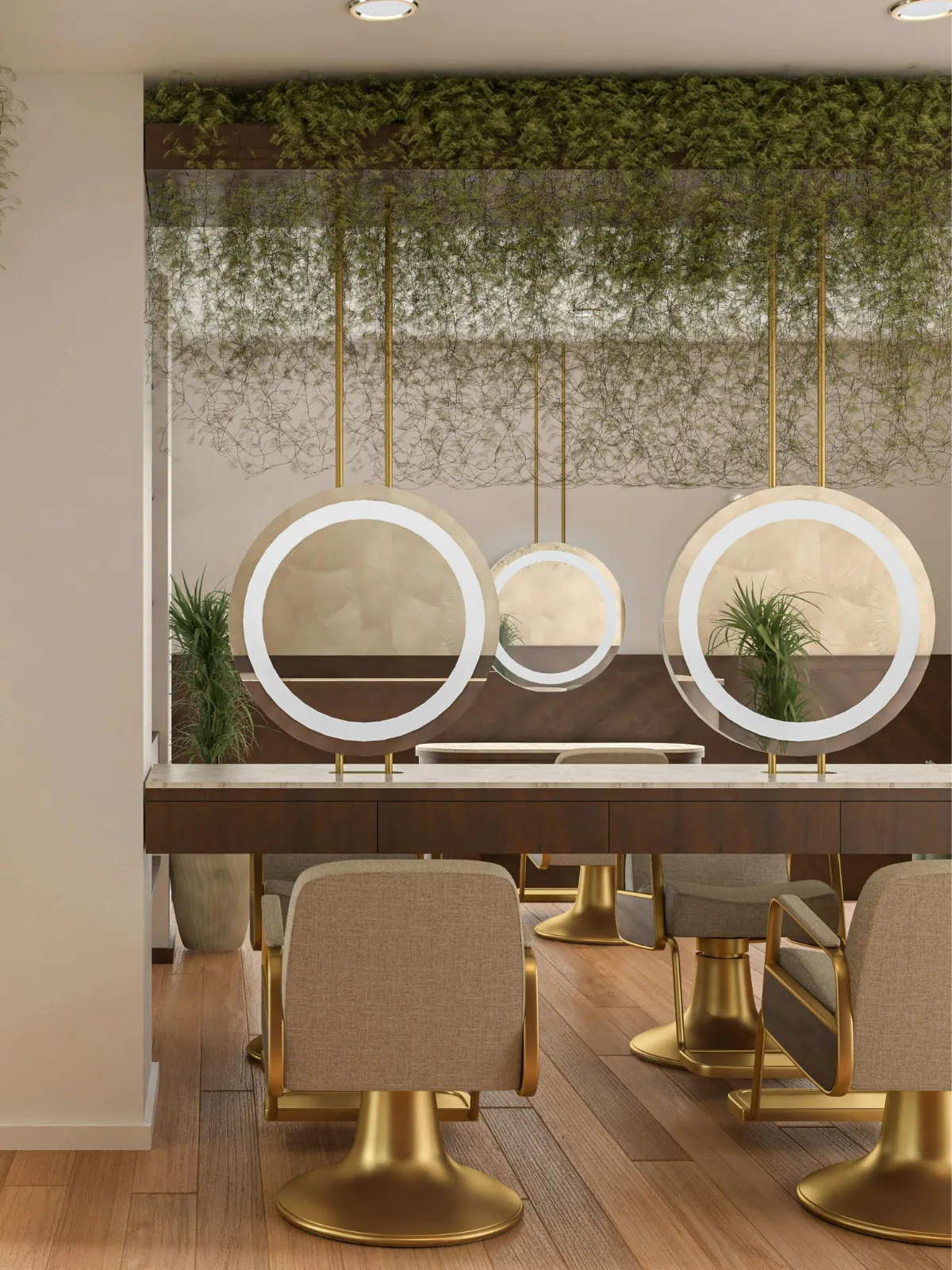 Styling stations along the wall, lit mirrors and gold chairs, plants overhead